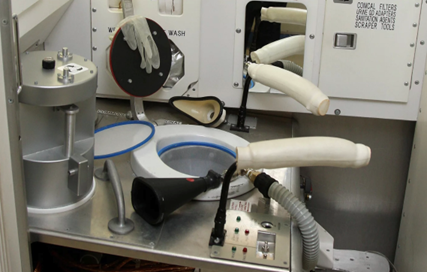 a toilet surrounded by tubes and handles, for space